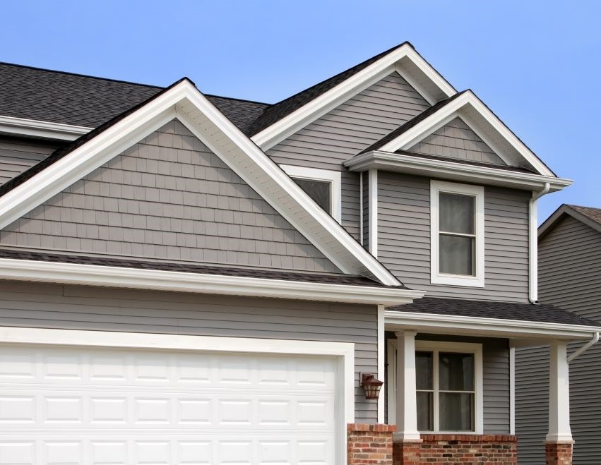 Newly installed grayish colored vinyl siding on residential home