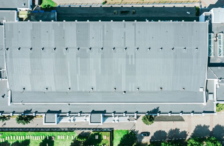 Arial view of a newly installed gray roof on commercial building