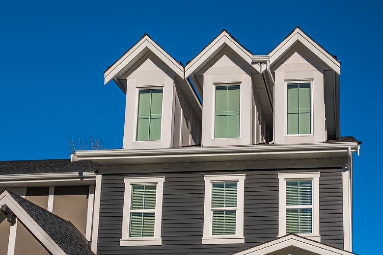 Newly installed windows on grayish colored residential home