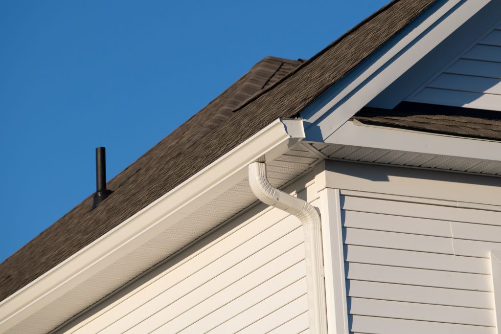 Stock image of cream colored gutter on a residential home